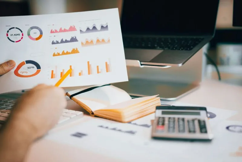 Fee-only financial advisor reviewing investment performance charts and financial planning data for a client 