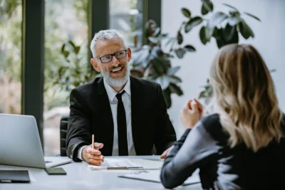Financial advisor speaking with a client during a personal finance consultation.
