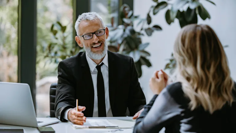 Financial advisor speaking with a client during a personal finance consultation.