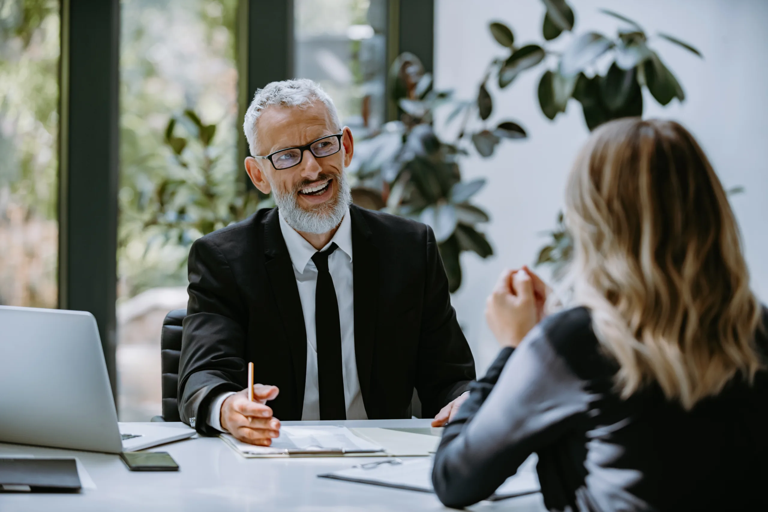 Financial advisor speaking with a client during a personal finance consultation.